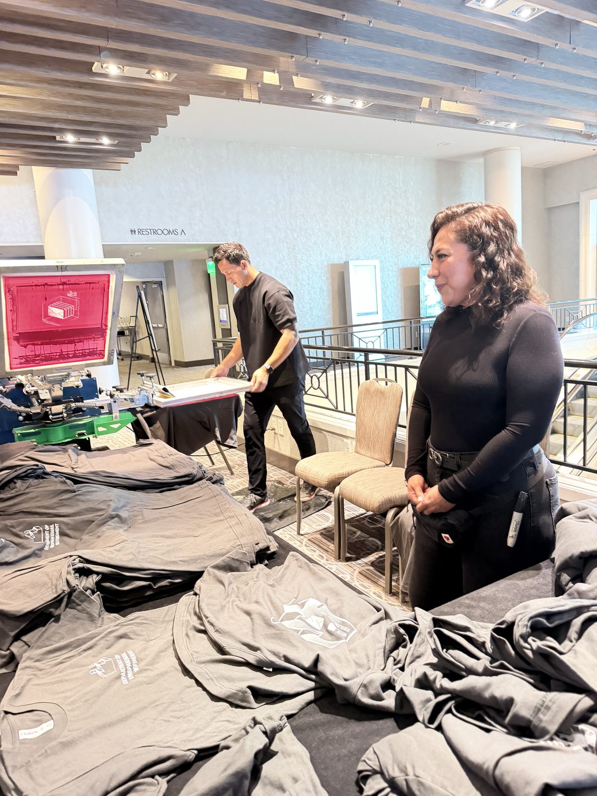 Merch Troop live event printing in Los Angeles — off the platen, still warm